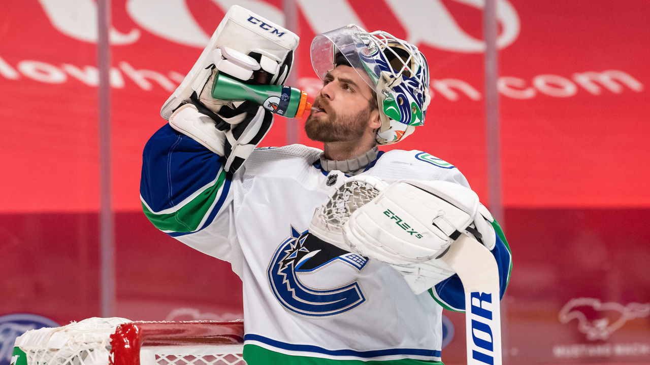 MONTREAL, QC - MARCH 20: Braden Holtby (49) of the Vancouver Canucks drinks during the first period of the NHL game between the Vancouver Canucks and the Montreal Canadiens on March 20, 2021, at the Bell Centre in Montreal, QC
