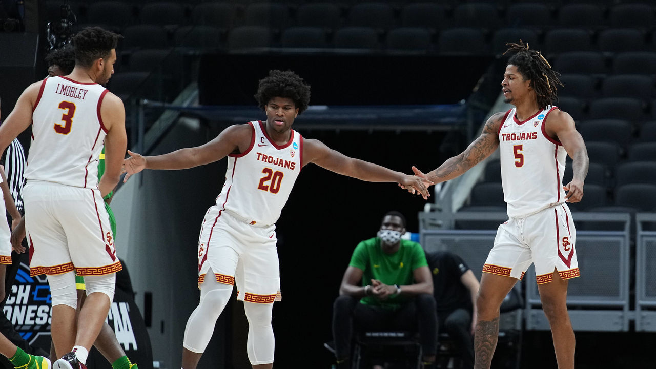 INDIANAPOLIS, IN - MARCH 28: Isaiah White #5 of the USC Trojans celebrates with teammates Isaiah Mobley #3 and Ethan Anderson #20 in the Sweet Sixteen round of the 2021 NCAA Division I Men's Basketball Tournament against the Oregon Ducks held at Bankers Life Fieldhouse on March 28, 2021 in Indianapolis, Indiana.