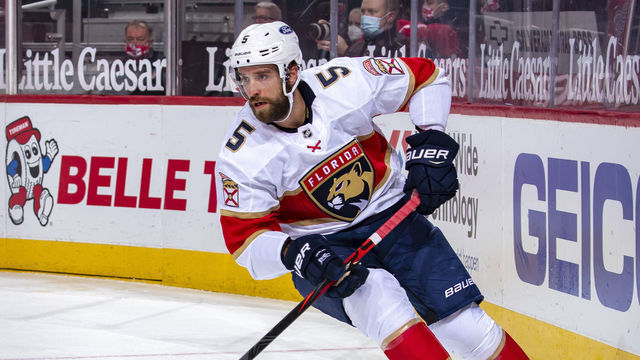 DETROIT, MI - JANUARY 31: Aaron Ekblad #5 of the Florida Panthers skates around the net with the puck against the Detroit Red Wings during an NHL game at Little Caesars Arena on January 31, 2021 in Detroit, Michigan. Florida defeated Detroit 3-2.