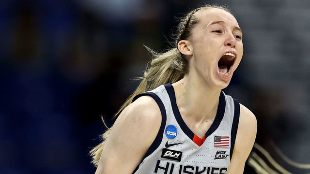 SAN ANTONIO, TEXAS - MARCH 29: Paige Bueckers #5 of the UConn Huskies celebrates her three point basket in the first quarter against the Baylor Lady Bears during the Elite Eight round of the NCAA Women's Basketball Tournament at the Alamodome on March 29, 2021 in San Antonio, Texas.