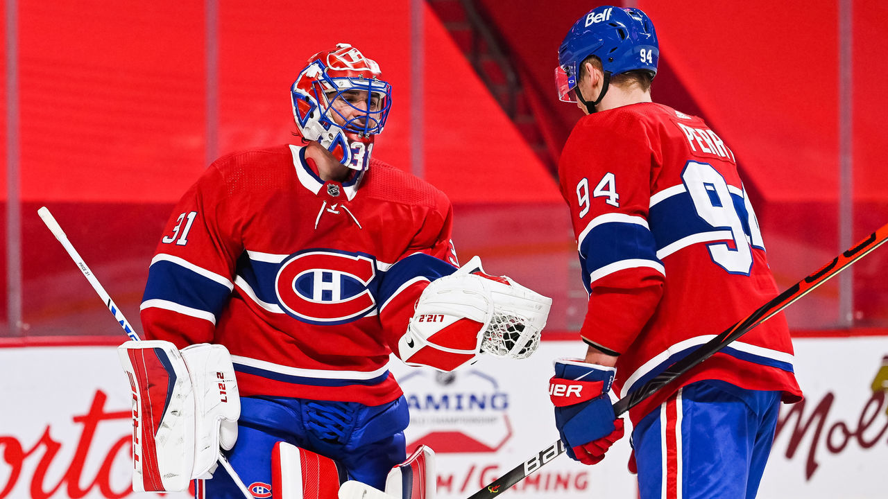 MONTREAL, QC - MARCH 30: Montreal Canadiens right wing Corey Perry (94) gives Montreal Canadiens goalie Carey Price (31) the winning game puck during the Edmonton Oilers versus the Montreal Canadiens game on March 30, 2021, at Bell Centre in Montreal, QC
