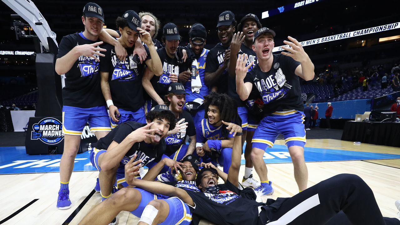 INDIANAPOLIS, INDIANA - MARCH 30: The UCLA Bruins celebrate defeating the Michigan Wolverines 51-49 in the Elite Eight round game of the 2021 NCAA Men's Basketball Tournament at Lucas Oil Stadium on March 30, 2021 in Indianapolis, Indiana.