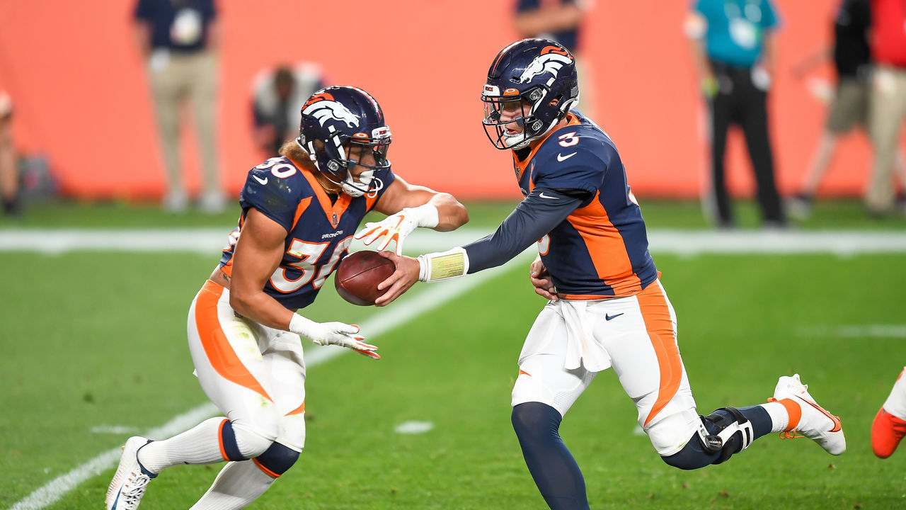 DENVER, CO - SEPTEMBER 14: Drew Lock #3 of the Denver Broncos hands off to Phillip Lindsay #30 against the Tennessee Titans at Empower Field at Mile High on September 14, 2020 in Denver, Colorado.