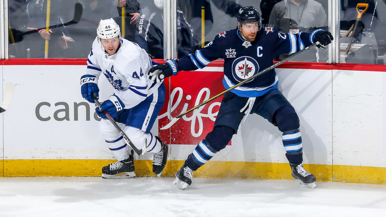 WINNIPEG, MB - MARCH 31: Morgan Rielly #44 of the Toronto Maple Leafs and Blake Wheeler #26 of the Winnipeg Jets keep an eye on the play during first period action at the Bell MTS Place on March 31, 2021 in Winnipeg, Manitoba, Canada.