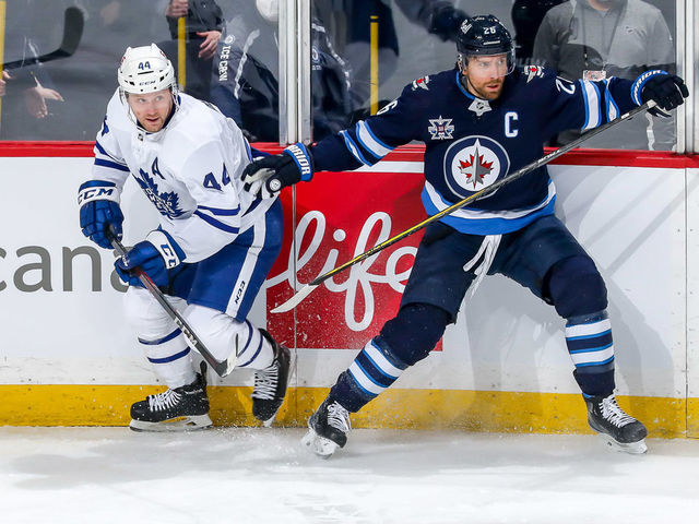 WINNIPEG, MB - MARCH 31: Morgan Rielly #44 of the Toronto Maple Leafs and Blake Wheeler #26 of the Winnipeg Jets keep an eye on the play during first period action at the Bell MTS Place on March 31, 2021 in Winnipeg, Manitoba, Canada.