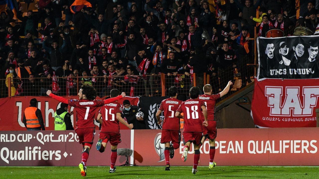 Armenia's players celebrate during the FIFA World Cup Qatar 2022 qualification football match Armenia v Romania in Yerevan on March 31, 2021.