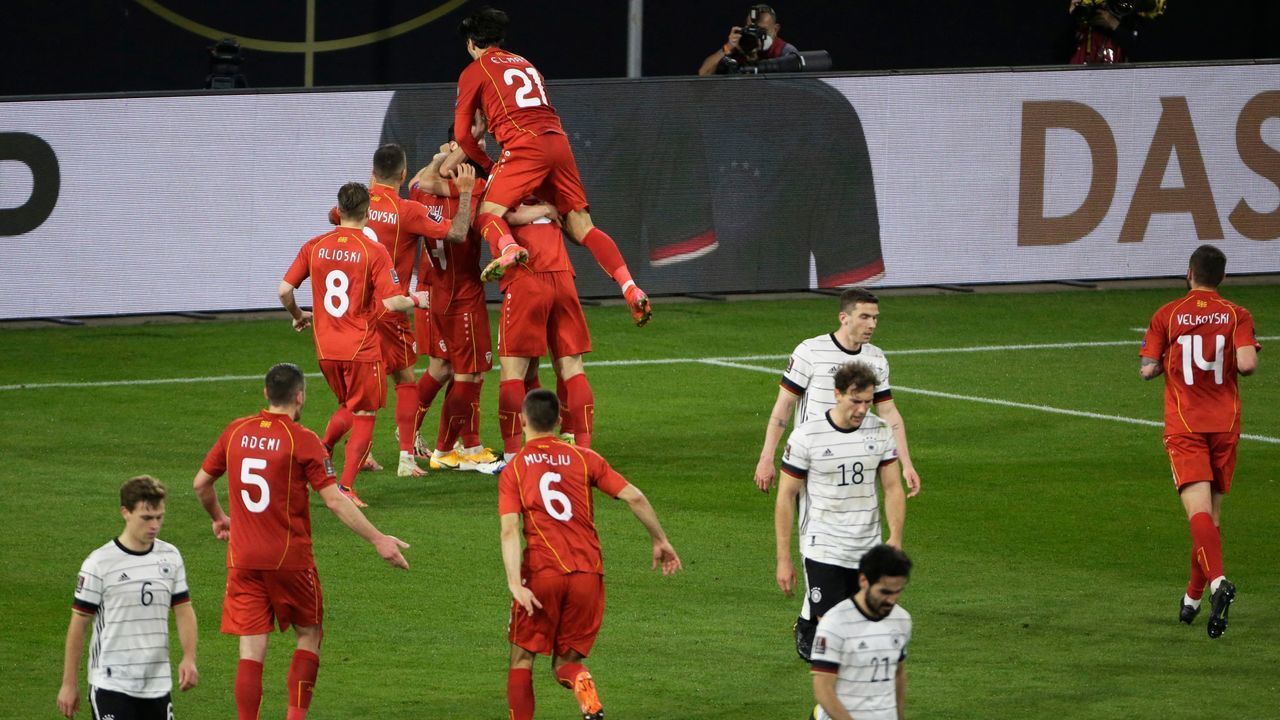 North Macedonia's forward Goran Pandev (hidden) celebrates scoring the opening goal with his teammates during the FIFA World Cup Qatar 2022 qualification football match Germany v North Macedonia in Duisburg, western Germany on March 31, 2021.