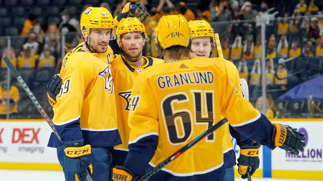 NASHVILLE, TN - MARCH 30: Roman Josi #59 celebrates his goal with Calle Jarnkrok #19, Eeli Tolvanen #28 and Mikael Granlund #64 of the Nashville Predators against the Dallas Stars during the second period at Bridgestone Arena on March 30, 2021 in Nashville, Tennessee.