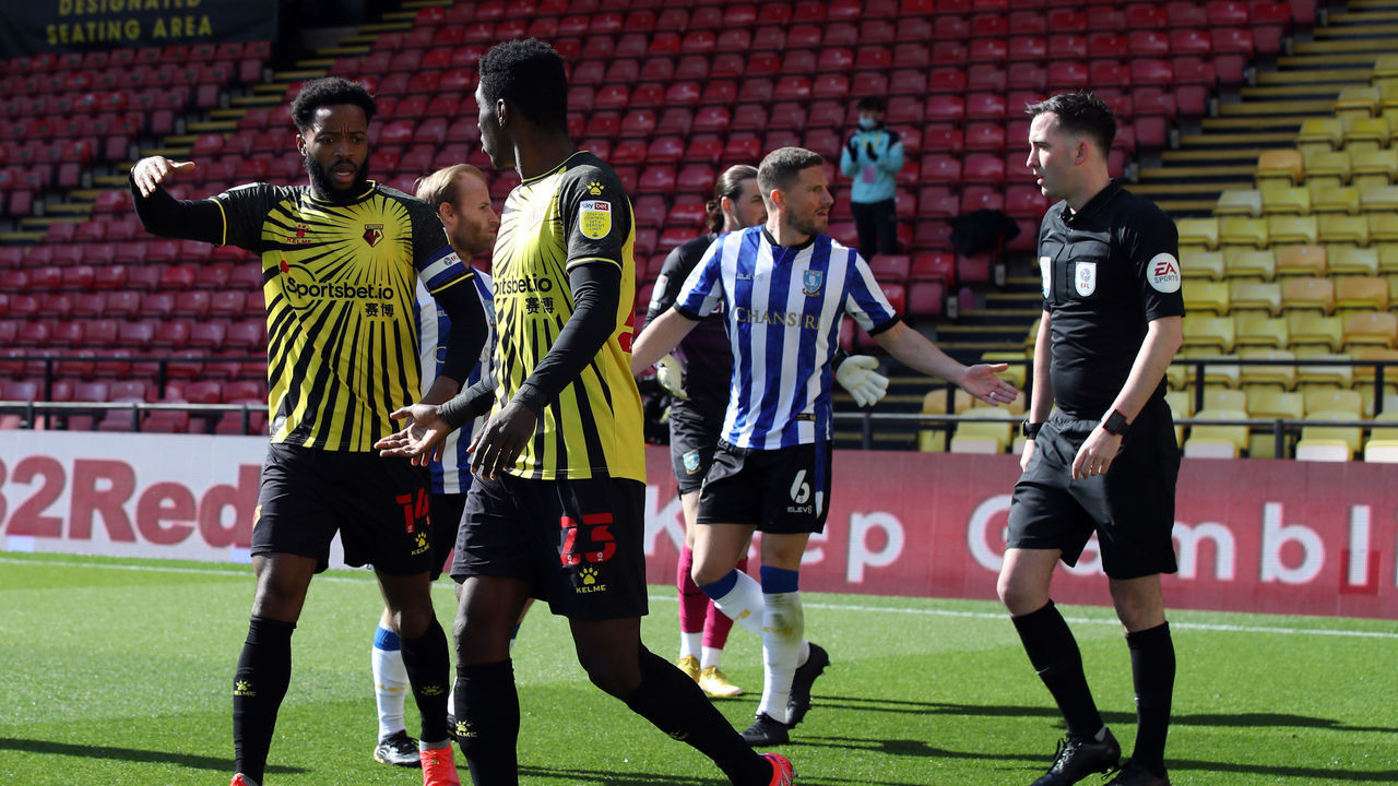 WATFORD, ENGLAND - APRIL 02: Nathaniel Chalobah and Ismaila Sarr of Watford celebrate the opening goal as Sam Hutchinson of Sheffield Wednesday complains to Referee Chris Kavanagh during the Sky Bet Championship match between Watford and Sheffield Wednesday at Vicarage Road on April 2, 2021 in Watford, England. Sporting stadiums around the UK remain under strict restrictions due to the Coronavirus Pandemic as Government social distancing laws prohibit fans inside venues resulting in games being played behind closed doors.