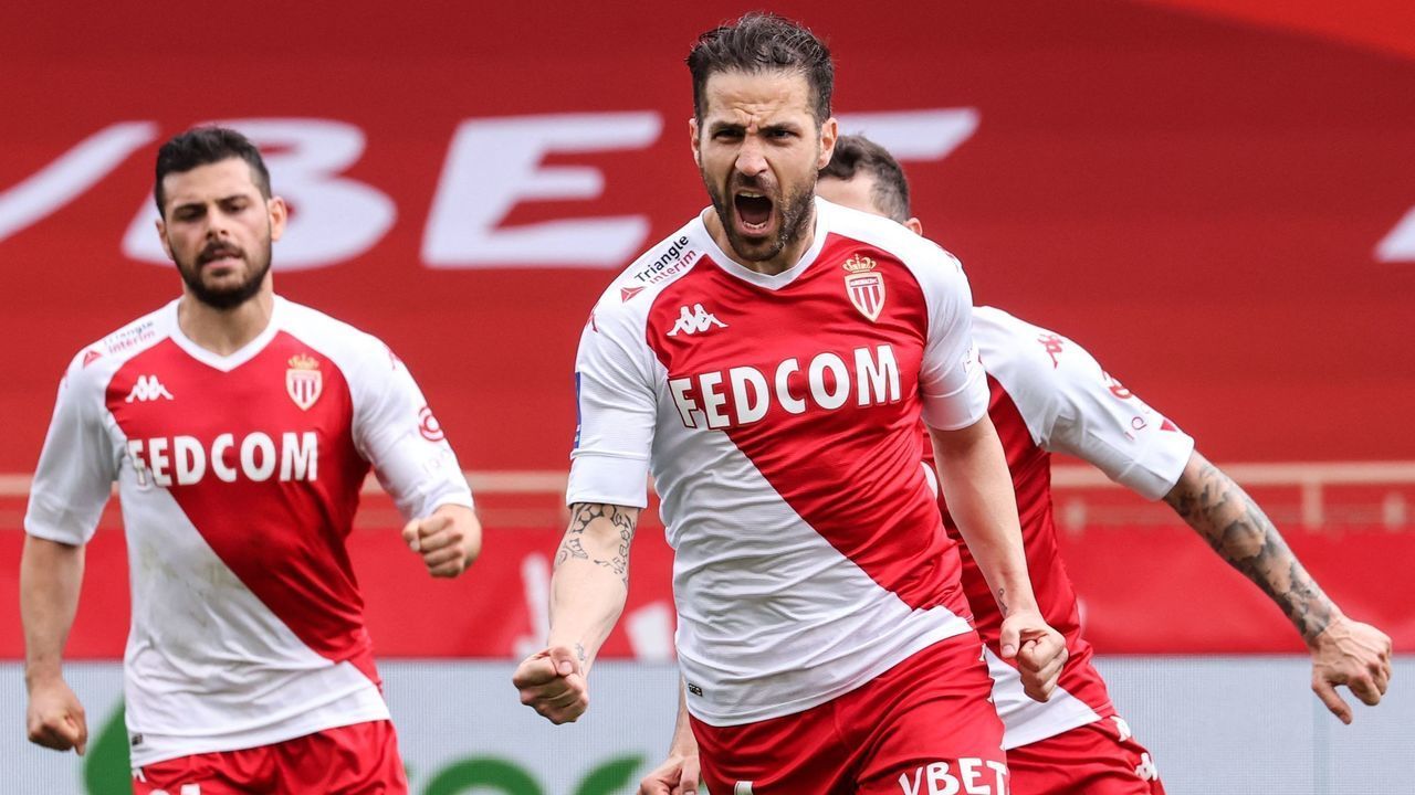 Monaco's Spanish midfielder Cesc Fabregas (C) celebrates with teammates after scoring a goal during the French L1 football match between AS Monaco and FC Metz at the "Louis II" stadium in Monaco, on April 3, 2021.