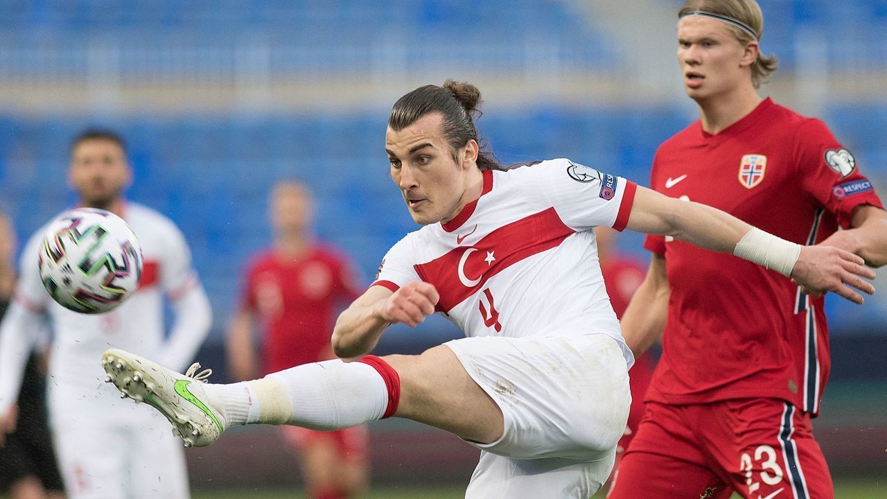 Turkey's defender Caglar Soyuncu (L) challenges Norway's forward Erling Braut Haaland during the FIFA World Cup Qatar 2022 qualification football match between Norway and Turkey at La Rosaleda stadium in Malaga on March 27, 2021.
