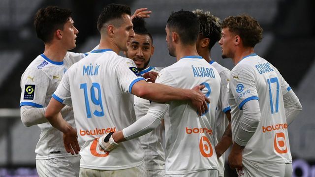 Marseille's Spanish defender Alvaro Gonzalez celebrates with teammates after scoring a goal during the French L1 football match between Olympique de Marseille (OM) and Dijon FCO at the Stade Velodrome in the southern French city of Marseille on April 4, 2021.