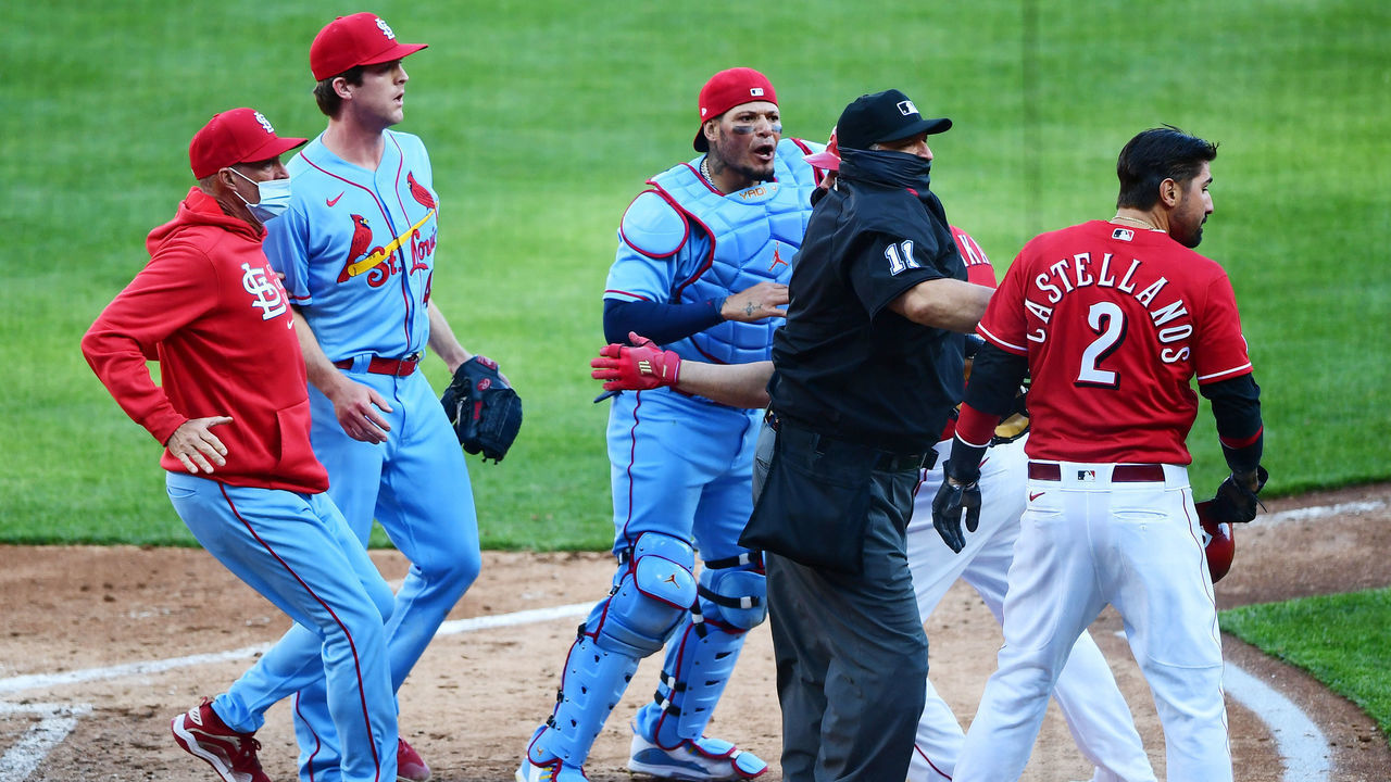 CINCINNATI, OHIO - APRIL 03: Yadier Molina #4 of the St. Louis Cardinals goes after Nick Castellanos #2 of the Cincinnati Reds after he slides safely into home base for a run in the fourth inning at Great American Ball Park on April 03, 2021 in Cincinnati, Ohio.