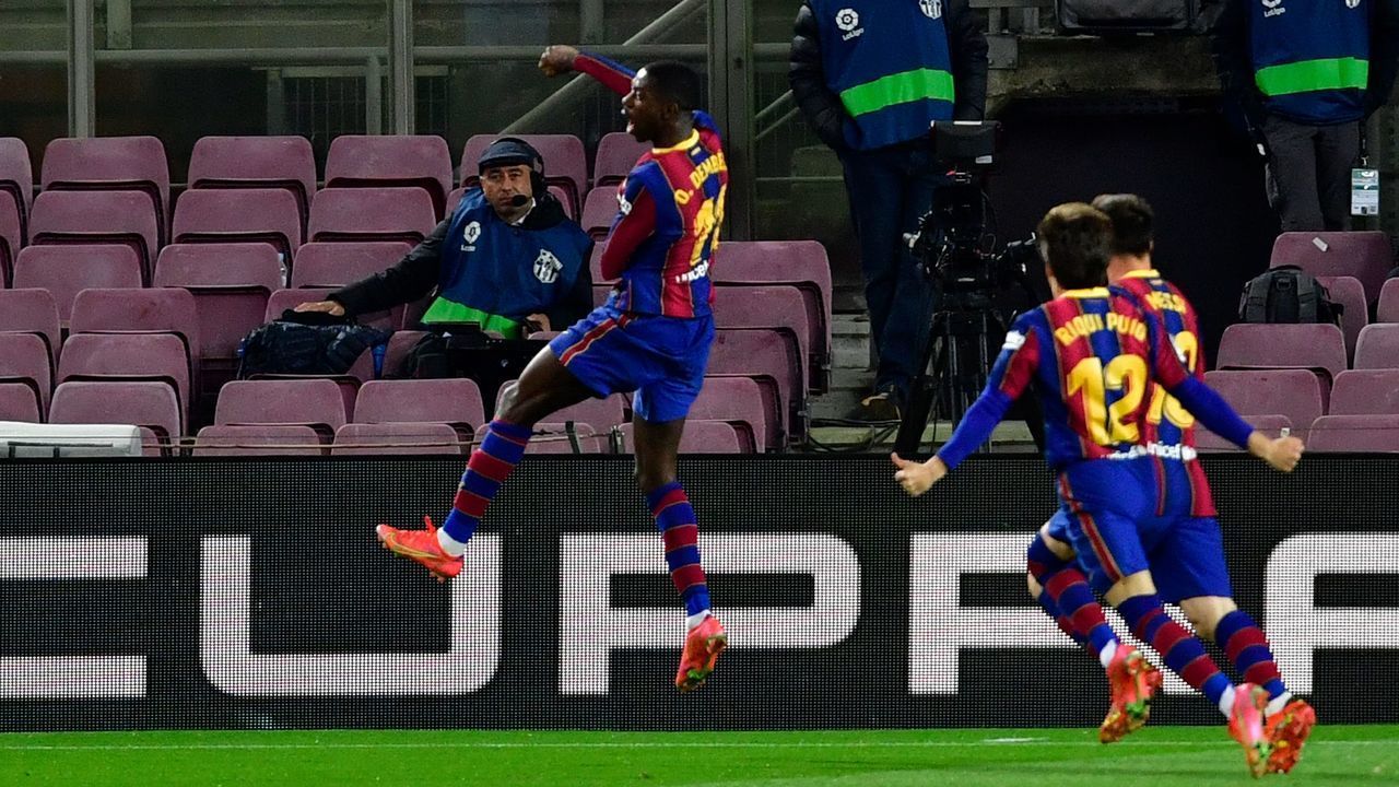 Barcelona's French forward Ousmane Dembele (C) celebrates after scoring during the Spanish League football match between FC Barcelona and Real Valladolid FC at the Camp Nou stadium in Barcelona on April 5, 2021.
