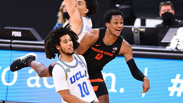 LAS VEGAS, NV - MARCH 11: UCLA Bruins guard Tyger Campbell (10) and Oregon State guard Gianni Hunt (0) watch a halfcourt shot to win the game in regulation that wouldnt fall during the second round game of the men's Pac-12 Tournament between the Oregon State Beavers and the UCLA Bruins on March 11, 2021, at the T-Mobile Arena in Las Vegas, NV.