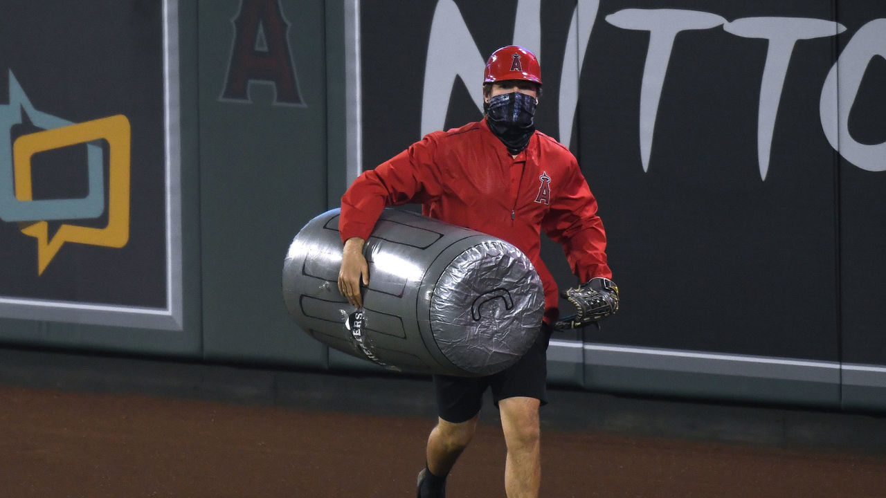 ANAHEIM, CALIFORNIA - APRIL 05: A member of the Los Angeles Angels grounds crew removes an inflated plastic trash can thrown on to the field during the sixth inning against the Houston Astros at Angel Stadium of Anaheim on April 05, 2021 in Anaheim, California.
