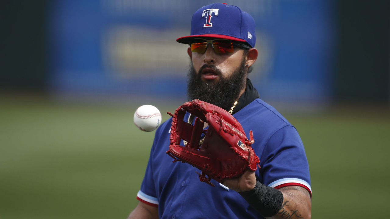 SURPRISE, ARIZONA - MARCH 07: Rougned Odor #12 of the Texas Rangers catches a ball prior to the MLB spring training baseball game against the Los Angeles Dodgers at Surprise Stadium on March 07, 2021 in Surprise, Arizona.