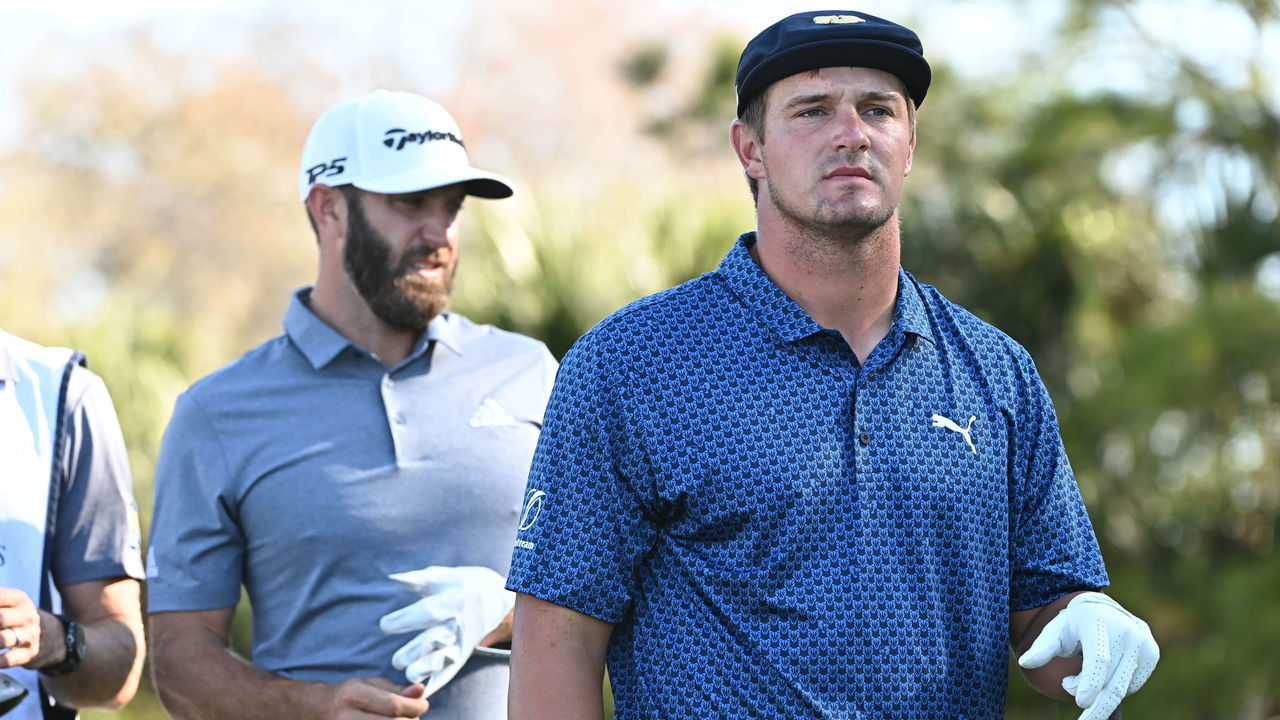 PONTE VEDRA BEACH, FL - MARCH 12: Dustin Johnson and Bryson DeChambeau walk down a fairway during the second round of THE PLAYERS Championship on THE PLAYERS Stadium Course at TPC Sawgrass on March 12, 2021, in Ponte Vedra Beach, FL.