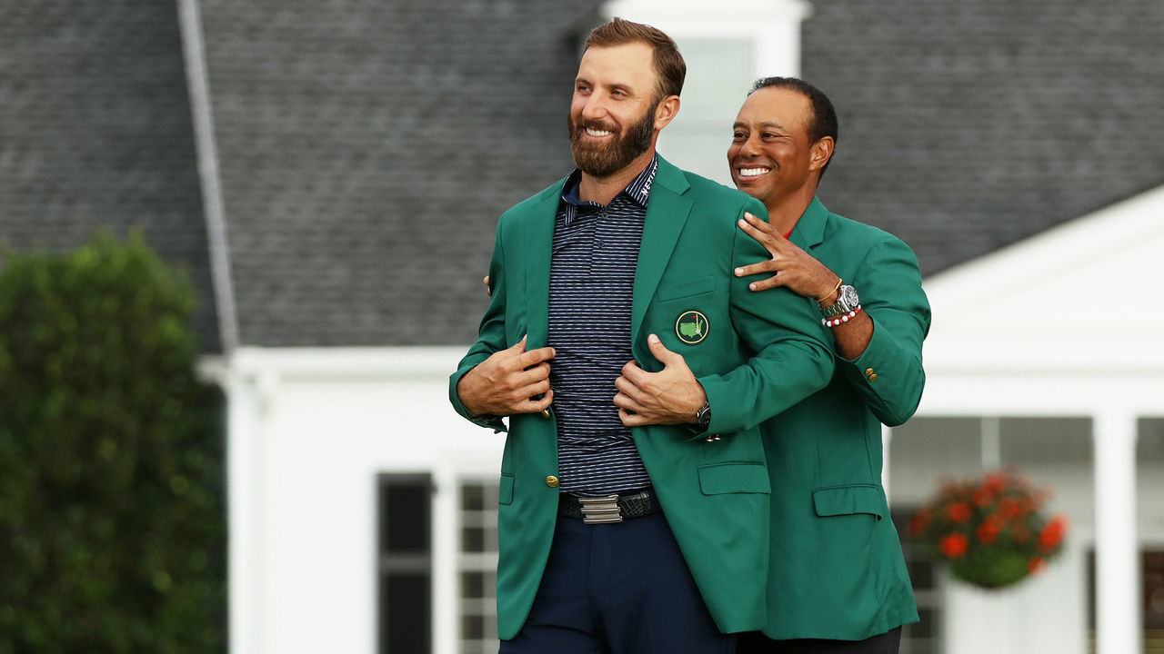 AUGUSTA, GEORGIA - NOVEMBER 15: Dustin Johnson of the United States is awarded the Green Jacket by Masters champion Tiger Woods of the United States during the Green Jacket Ceremony after winning the Masters at Augusta National Golf Club on November 15, 2020 in Augusta, Georgia.