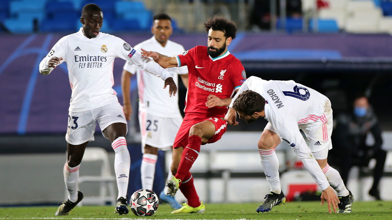 Liverpool's Mohamed Salah (centre) battles for the ball with Real Madrid's Ferland Mendy (left) and Fernandez Nacho during the UEFA Champions League match at the Alfredo Di Stefano Stadium, Madrid. Picture date: Tuesday April 6, 2021.