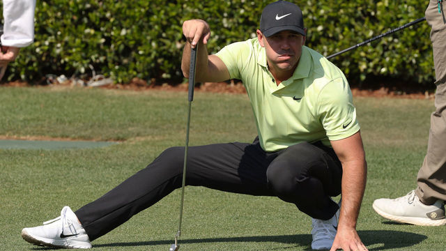 AUGUSTA, GEORGIA - APRIL 06: Brooks Koepka of the United States crouches as he lines up a putt on the practice green during a practice round prior to the Masters at Augusta National Golf Club on April 06, 2021 in Augusta, Georgia.