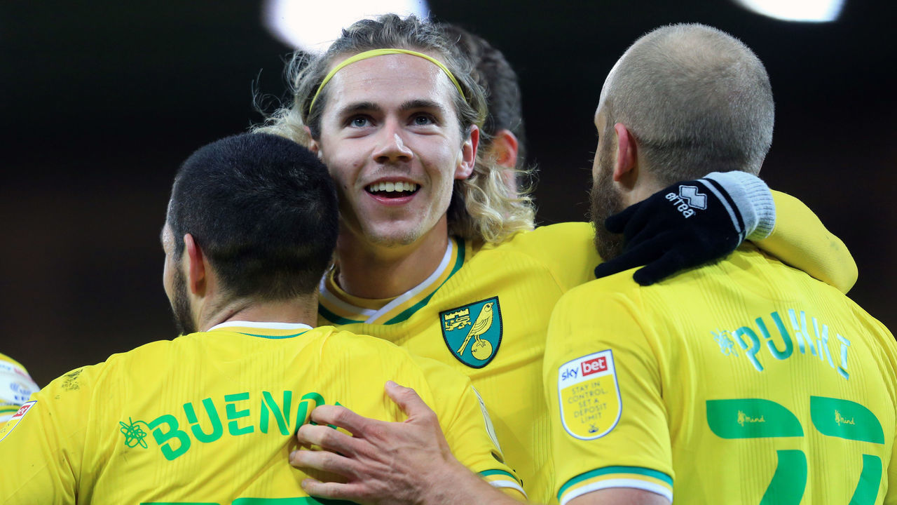 NORWICH, ENGLAND - APRIL 06: Todd Cantwell of Norwich City (C) celebrates with goal scorer Emi Buendia of Norwich City after he scored their team's third goal during the Sky Bet Championship match between Norwich City and Huddersfield Town at Carrow Road on April 06, 2021 in Norwich, England. Sporting stadiums around the UK remain under strict restrictions due to the Coronavirus Pandemic as Government social distancing laws prohibit fans inside venues resulting in games being played behind closed doors.