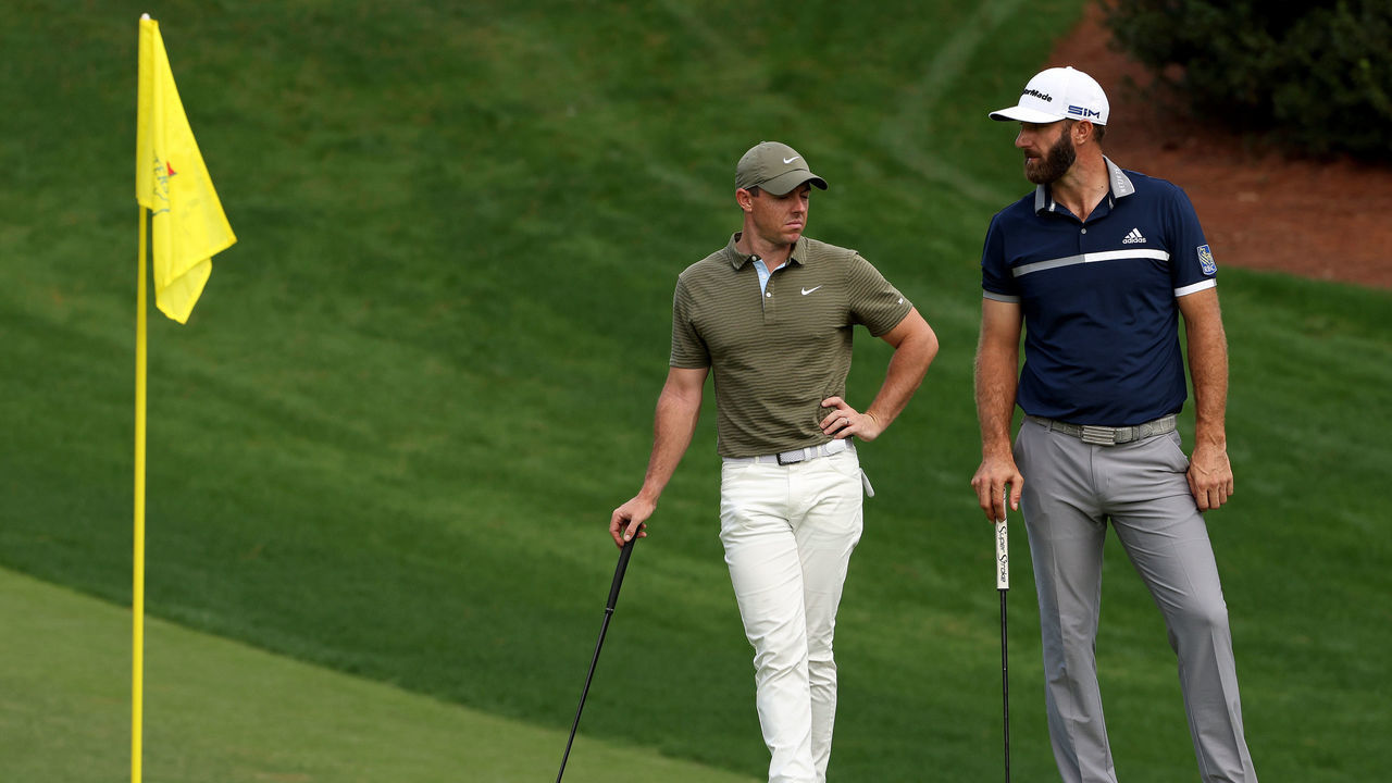 AUGUSTA, GEORGIA - NOVEMBER 13: Rory McIlroy of Northern Ireland stands with Dustin Johnson of the United States on the 10th green during the second round of the Masters at Augusta National Golf Club on November 13, 2020 in Augusta, Georgia.