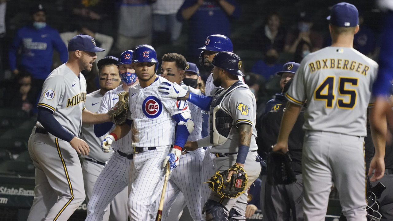 CHICAGO, ILLINOIS - APRIL 06: Willson Contreras #40 of the Chicago Cubs stares down Brad Boxberger #45 of the Milwaukee Brewers after he was hit by a pitch during the ninth inning of a game at Wrigley Field on April 06, 2021 in Chicago, Illinois.