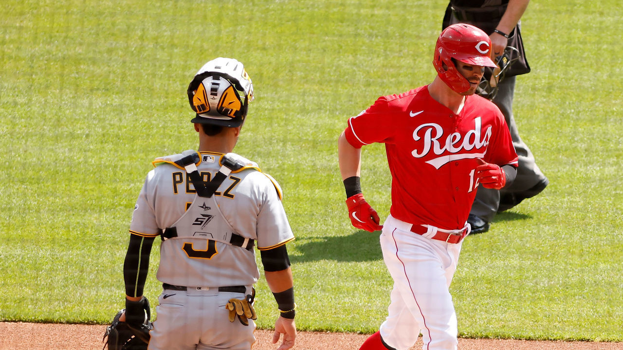 CINCINNATI, OH - APRIL 07: Tyler Naquin #12 of the Cincinnati Reds crosses home plate after hitting a solo home run during the first inning of the game against the Pittsburgh Pirates at Great American Ball Park on April 7, 2021 in Cincinnati, Ohio.