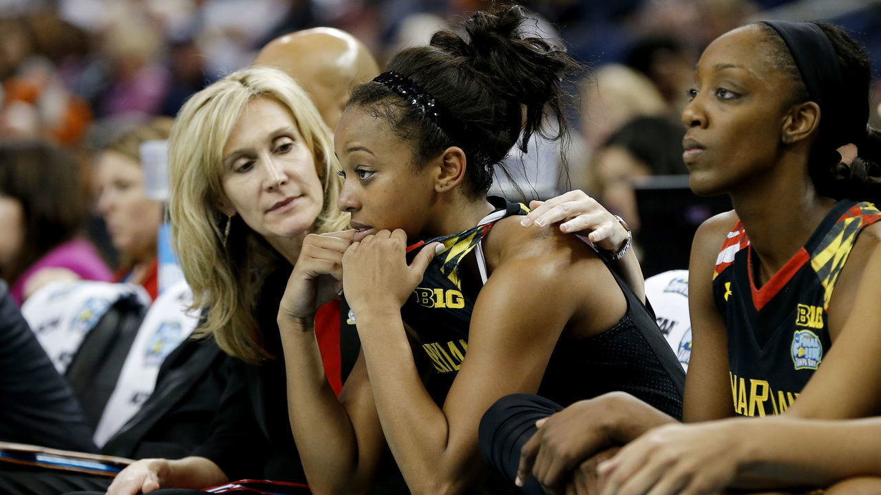 TAMPA, FL - APRIL 05: Lexie Brown #4 of the Maryland Terrapins is comforted by Associate Head Coach Tina Langley on the bench in their 81 to 58 loss to the Connecticut Huskies during the NCAA Women's Final Four Semifinal at Amalie Arena on April 5, 2015 in Tampa, Florida.