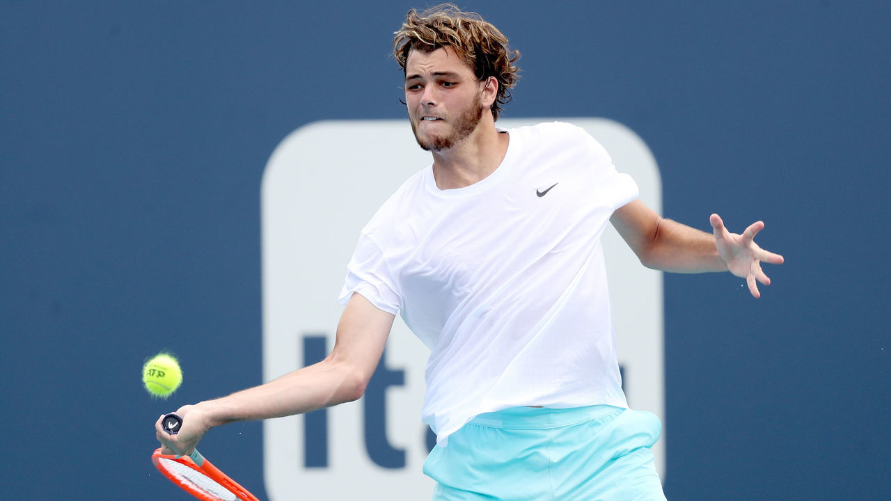 MIAMI GARDENS, FLORIDA - MARCH 30: Taylor Fritz returns a shot to Alexander Bublik of Kazakhstan during the Miami Open at Hard Rock Stadium on March 30, 2021 in Miami Gardens, Florida.