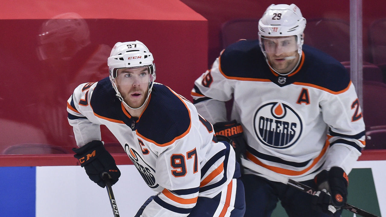 MONTREAL, QC - APRIL 05: Connor McDavid #97 of the Edmonton Oilers skates the puck past teammate Leon Draisaitl #29 during the third period against the Montreal Canadiens at the Bell Centre on April 5, 2021 in Montreal, Canada. The Montreal Canadiens defeated the Edmonton Oilers 3-2 in overtime.