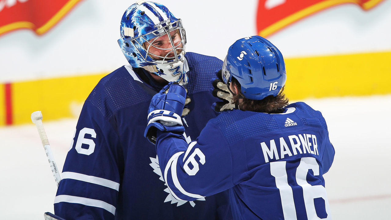 TORONTO, ON - APRIL 7: Jack Campbell #36 of the Toronto Maple Leafs is congratulated by teammate Mitchell Marner #16 for breaking the consecutive wins by a Leafs goaltender against the Montreal Canadiens in an NHL game at Scotiabank Arena on April 7, 2021 in Toronto, Ontario, Canada. The Maple Leafs defeated the Canadiens 3-2.