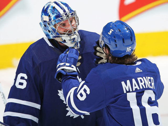 TORONTO, ON - APRIL 7: Jack Campbell #36 of the Toronto Maple Leafs is congratulated by teammate Mitchell Marner #16 for breaking the consecutive wins by a Leafs goaltender against the Montreal Canadiens in an NHL game at Scotiabank Arena on April 7, 2021 in Toronto, Ontario, Canada. The Maple Leafs defeated the Canadiens 3-2.