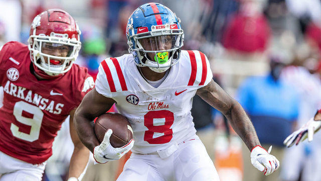 FAYETTEVILLE, AR - OCTOBER 17: Elijah Moore #8 of the Mississippi Rebels runs past Greg Brooks Jr. #9 of the Arkansas Razorbacks at Razorback Stadium on October 17, 2020 in Fayetteville, Arkansas. The Razorbacks defeated the Rebels 33-21.