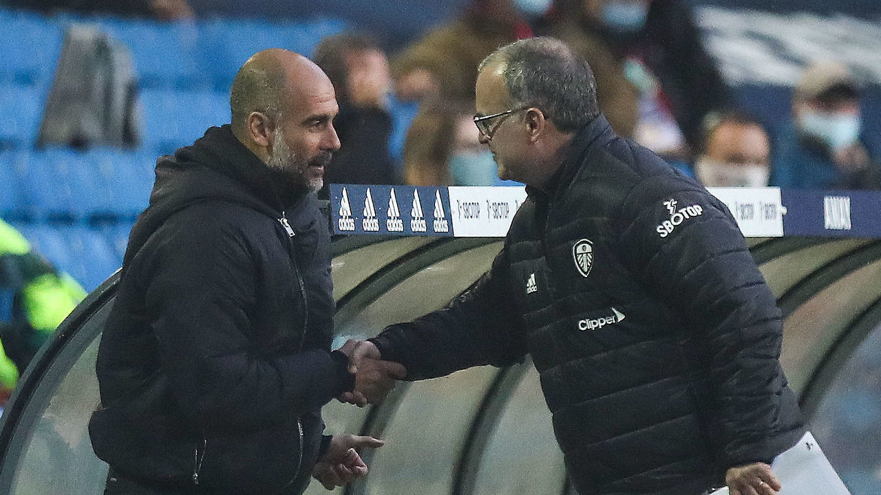 LEEDS, ENGLAND - OCTOBER 03: Pep Guardiola the head coach / manager of Manchester City and Marcelo Bielsa the manager / head coach of Leeds United shake hands during the Premier League match between Leeds United and Manchester City at Elland Road on October 3, 2020 in Leeds, United Kingdom. Sporting stadiums around the UK remain under strict restrictions due to the Coronavirus Pandemic as Government social distancing laws prohibit fans inside venues resulting in games being played behind closed doors.