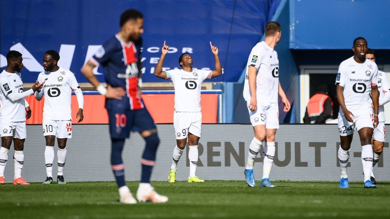 Lille's Canadian forward Jonathan David (C-L) celebrates after scoring a goal during the French L1 football match between Paris-Saint Germain (PSG) and Lille (LOSC) at the Parc des Princes Stadium in Paris, on April 3, 2021.