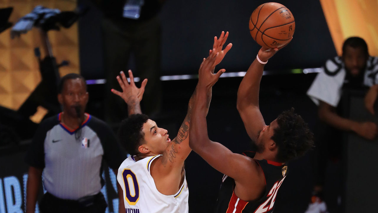 LAKE BUENA VISTA, FLORIDA - OCTOBER 11: Kyle Kuzma #0 of the Los Angeles Lakers defends Jimmy Butler #22 of the Miami Heat during the second quarter in Game Six of the 2020 NBA Finals at AdventHealth Arena at the ESPN Wide World Of Sports Complex on October 11, 2020 in Lake Buena Vista, Florida.
