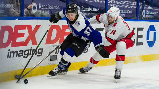TAMPA, FL - FEBRUARY 25: Yanni Gourde #37 of the Tampa Bay Lightning skates against Jaccob Slavin #74 of the Carolina Hurricanes during the third period at Amalie Arena on February 25, 2021 in Tampa, Florida.
