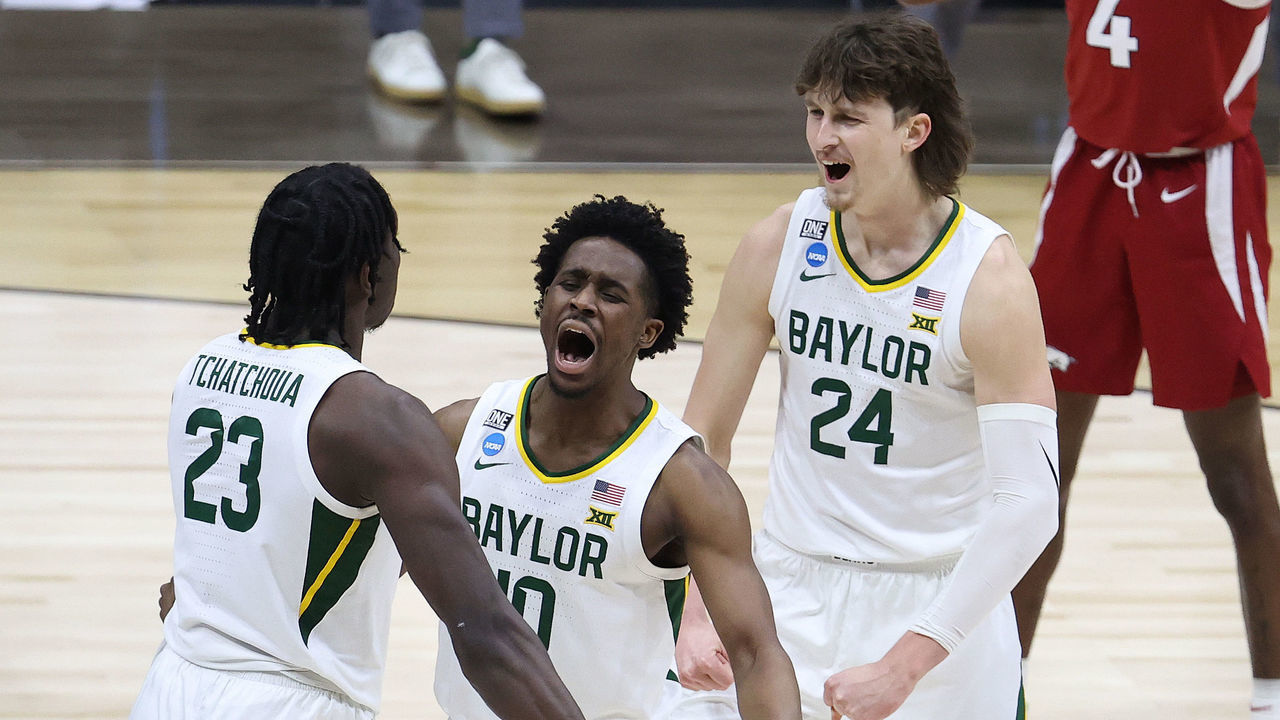 INDIANAPOLIS, INDIANA - MARCH 29: Adam Flagler #10 of the Baylor Bears celebrates with Jonathan Tchamwa Tchatchoua #23 and Matthew Mayer #24 against the Arkansas Razorbacks during the second half in the Elite Eight round of the 2021 NCAA Men's Basketball Tournament at Lucas Oil Stadium on March 29, 2021 in Indianapolis, Indiana.