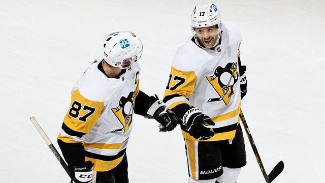 NEWARK, NEW JERSEY - APRIL 09: Bryan Rust #17 of the Pittsburgh Penguins celebrates his empty net goal with teammate Sidney Crosby #87 in the third period against the New Jersey Devils at Prudential Center on April 09, 2021 in Newark, New Jersey.The Pittsburgh Penguins defeated the New Jersey Devils 6-4.