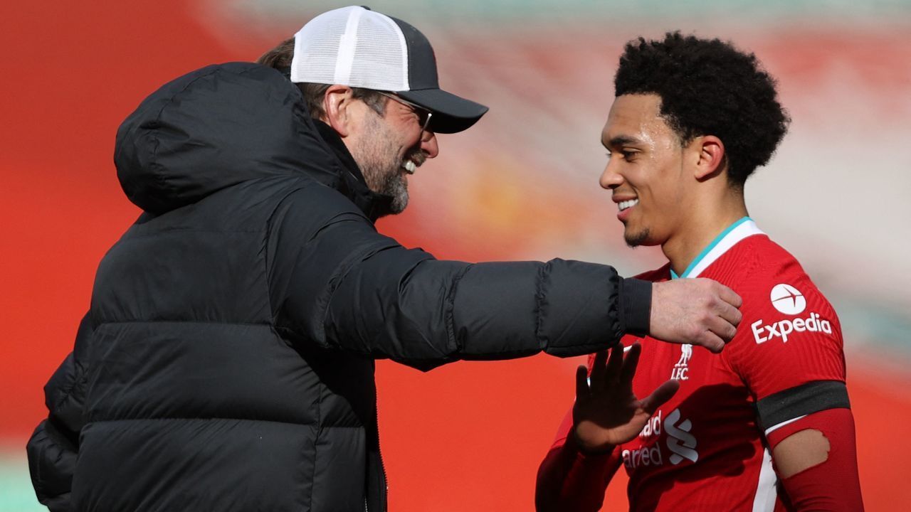 Liverpool's German manager Jurgen Klopp (L) congratulates Liverpool's English defender Trent Alexander-Arnold after the English Premier League football match between Liverpool and Aston Villa at Anfield in Liverpool, north west England on April 10, 2021. - Liverpool won the match 2-0. - RESTRICTED TO EDITORIAL USE. No use with unauthorized audio, video, data, fixture lists, club/league logos or 'live' services. Online in-match use limited to 120 images. An additional 40 images may be used in extra time. No video emulation. Social media in-match use limited to 120 images. An additional 40 images may be used in extra time. No use in betting publications, games or single club/league/player publications.