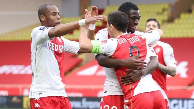 Monaco's French forward Wissam Ben Yedder (R) celebrates with teammates after scoring a goal during the French L1 football match between AS Monaco and Dijon at "Louis II" stadium in Monaco, on April 11, 2021.
