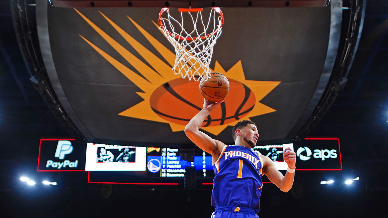PHOENIX, AZ - MARCH 4: Devin Booker #1 of the Phoenix Suns grabs a rebound against the Golden State Warriors on March 4, 2021 at Talking Stick Resort Arena in Phoenix, Arizona. Mandatory Copyright Notice: Copyright 2021 NBAE