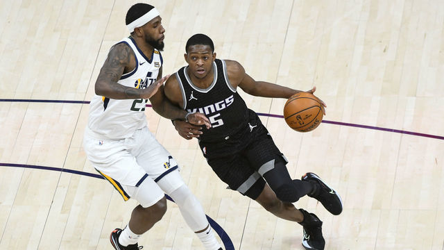 SALT LAKE CITY, UTAH - APRIL 10: De'Aaron Fox #5 of the Sacramento Kings drives around Royce O'Neale #23 of the Utah Jazz during a game at Vivint Smart Home Arena on April 10, 2021 in Salt Lake City, Utah. NOTE TO USER: User expressly acknowledges and agrees that, by downloading and/or using this photograph, user is consenting to the terms and conditions of the Getty Images License Agreement.