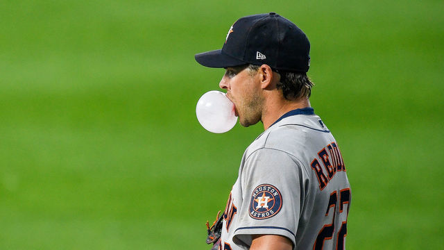 DENVER, CO - AUGUST 19: Houston Astros right fielder Josh Reddick (22) blows a bubble gum bubble as he stands in the outfield during a game against the Colorado Rockies at Coors Field in Denver, Colorado on August 19, 2020.