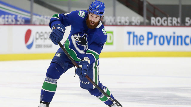 VANCOUVER, BC - MARCH 22: Jordie Benn #8 of the Vancouver Canucks takes a shot during their NHL game against the Winnipeg Jets at Rogers Arena on March 22, 2021 in Vancouver, British Columbia, Canada. "n