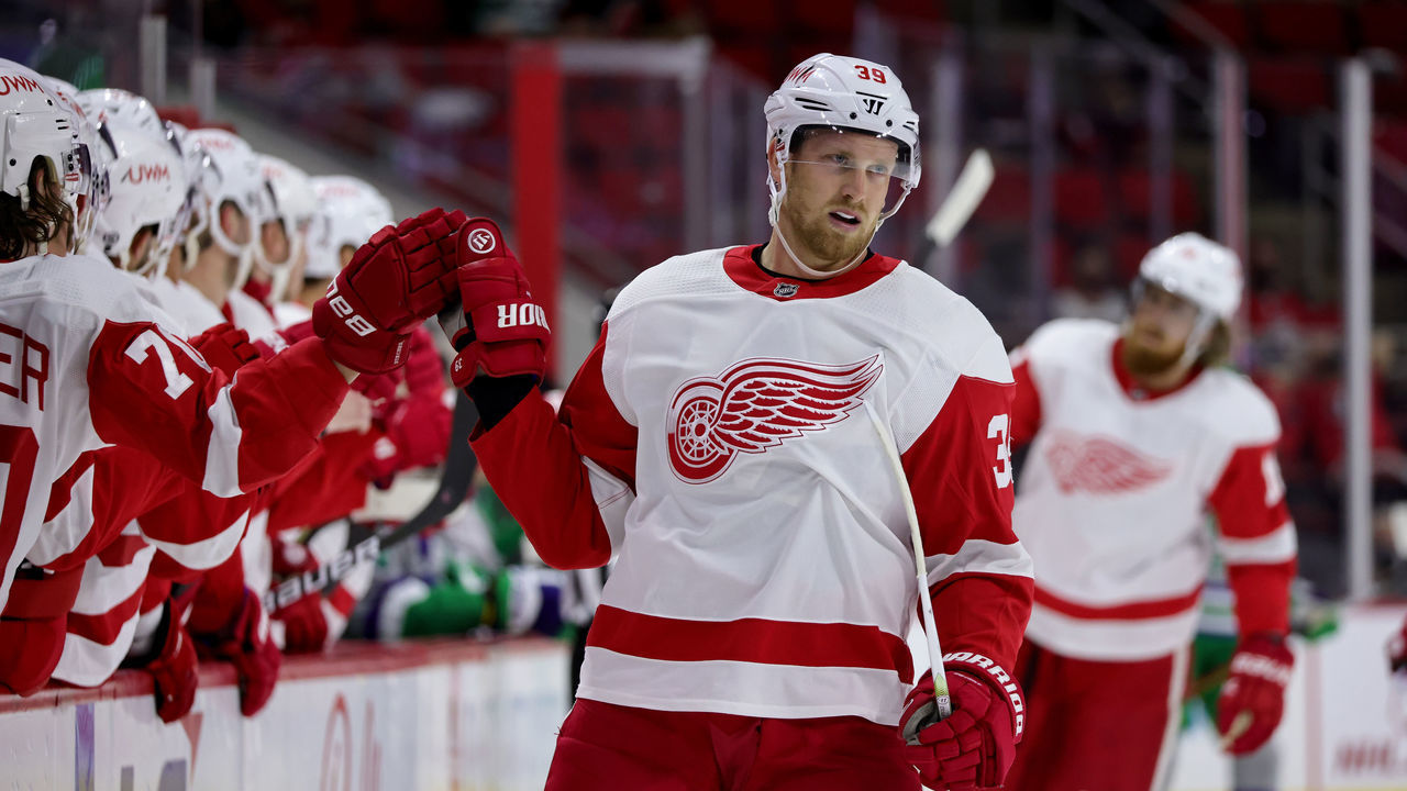 RALEIGH, NC - APRIL 10: Anthony Mantha #39 of the Detroit Red Wings scores a goal and skates back to the bench to celebrate with teammates during an NHL game against the Carolina Hurricanes on April 10, 2021 at PNC Arena in Raleigh, North Carolina.