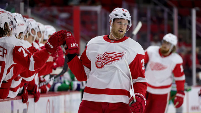 RALEIGH, NC - APRIL 10: Anthony Mantha #39 of the Detroit Red Wings scores a goal and skates back to the bench to celebrate with teammates during an NHL game against the Carolina Hurricanes on April 10, 2021 at PNC Arena in Raleigh, North Carolina.