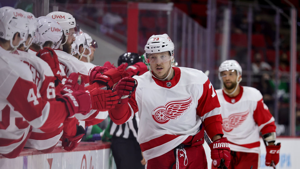 RALEIGH, NC - APRIL 10: Adam Erne #73 of the Detroit Red Wings skates back to the bench to celebrate with teammates after scoring a goal during an NHL game against the Carolina Hurricanes on April 10, 2021 at PNC Arena in Raleigh, North Carolina.